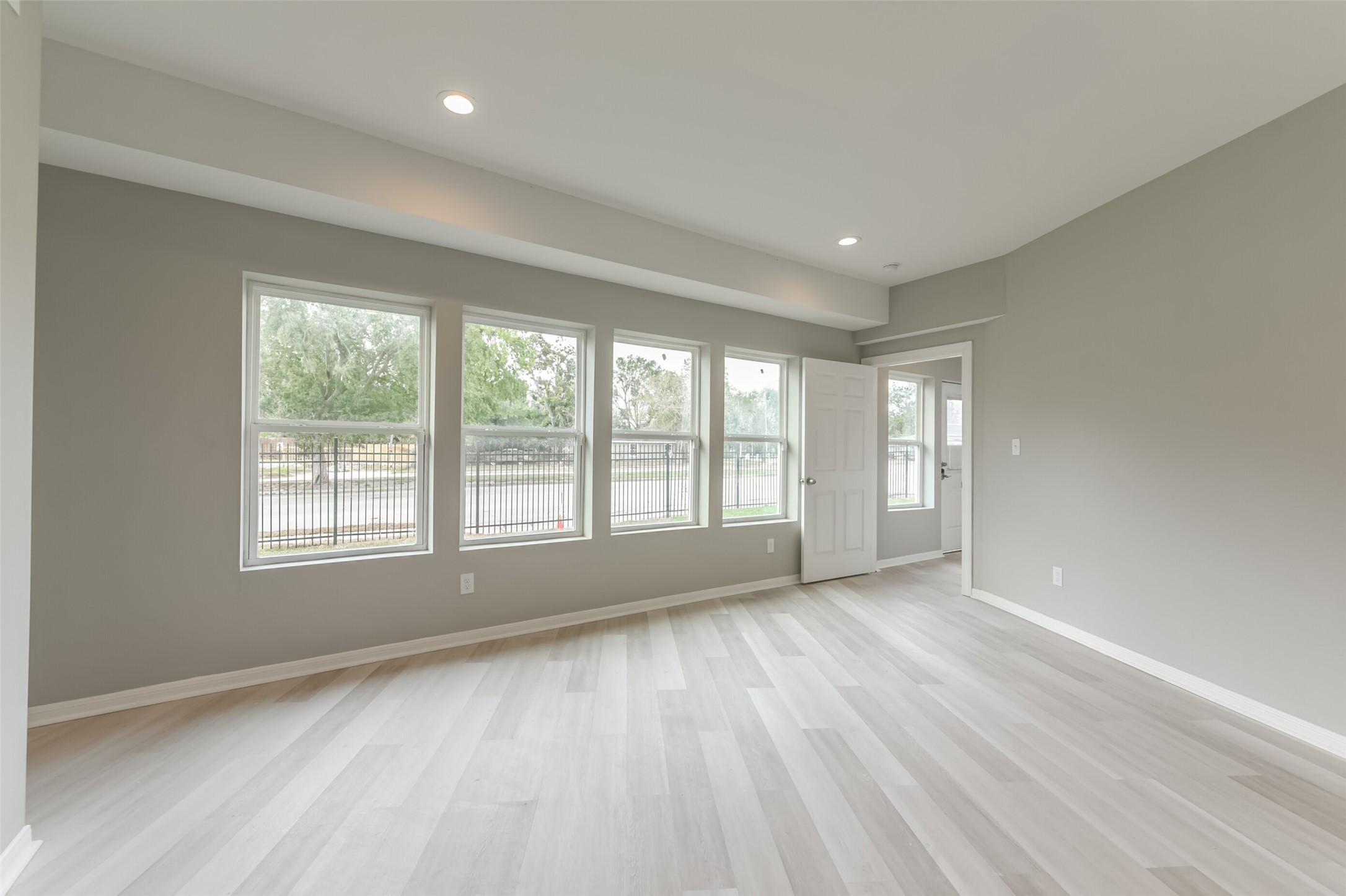5302 Tarawa Road Houston, TX 77033 - Photo 8 of 35 a view of an empty room with a window and wooden floor
