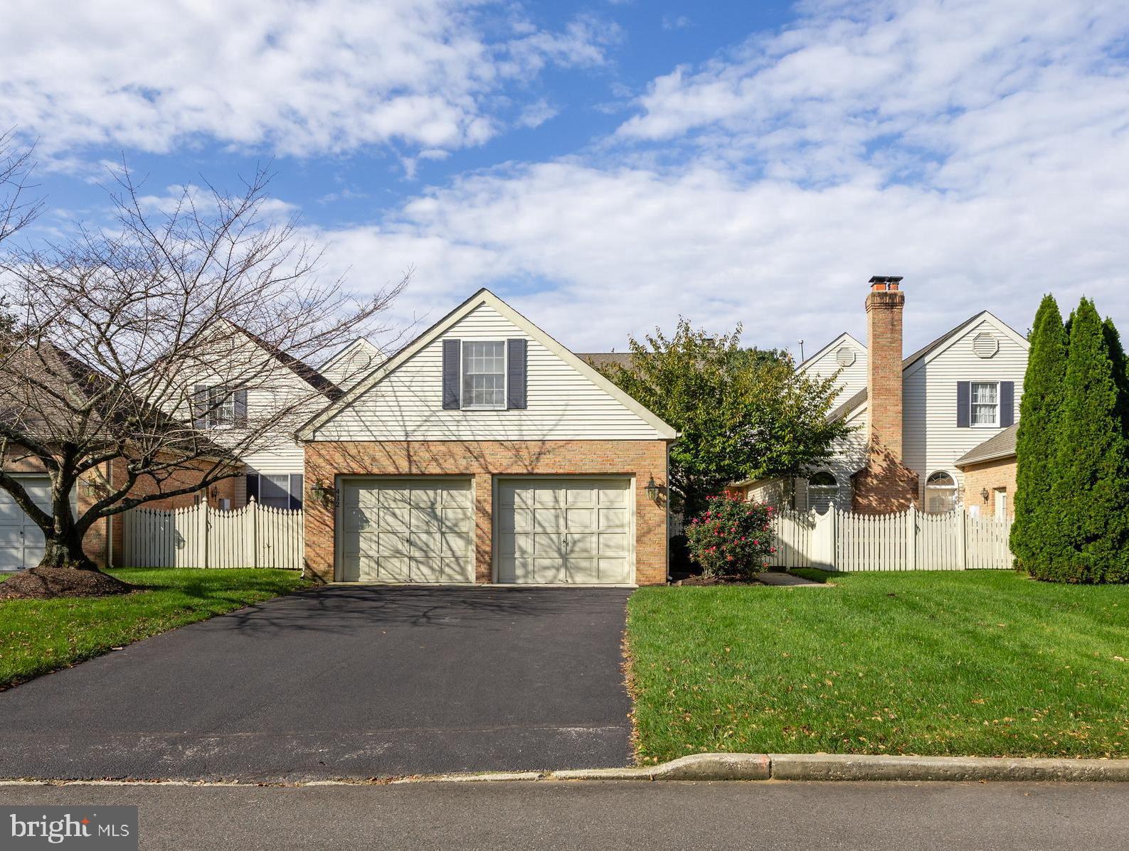 a front view of a house with a garden and yard