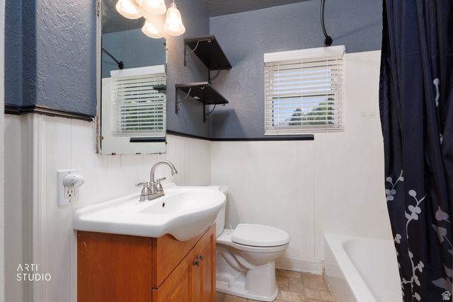 146 West 200 N Street Springville, UT 84663 - Photo 16 of 29 Bathroom featuring a wood-finish vanity with an integrated white basin, brushed nickel faucet, and a window with horizontal blinds