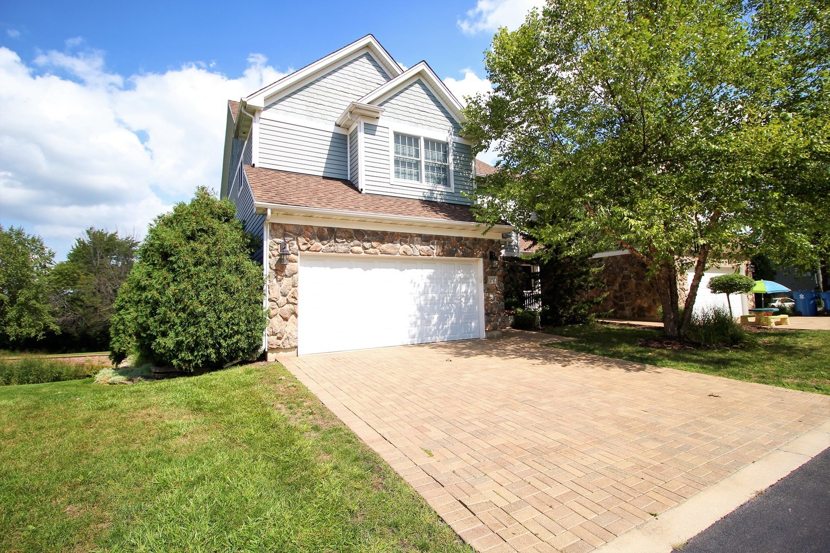 a front view of a house with a yard and garage