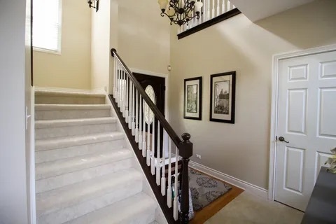 2522 Reflections Drive Crest Hill, IL 60403 - Photo 8 of 18 a view of staircase with lots of frames on wall and a window