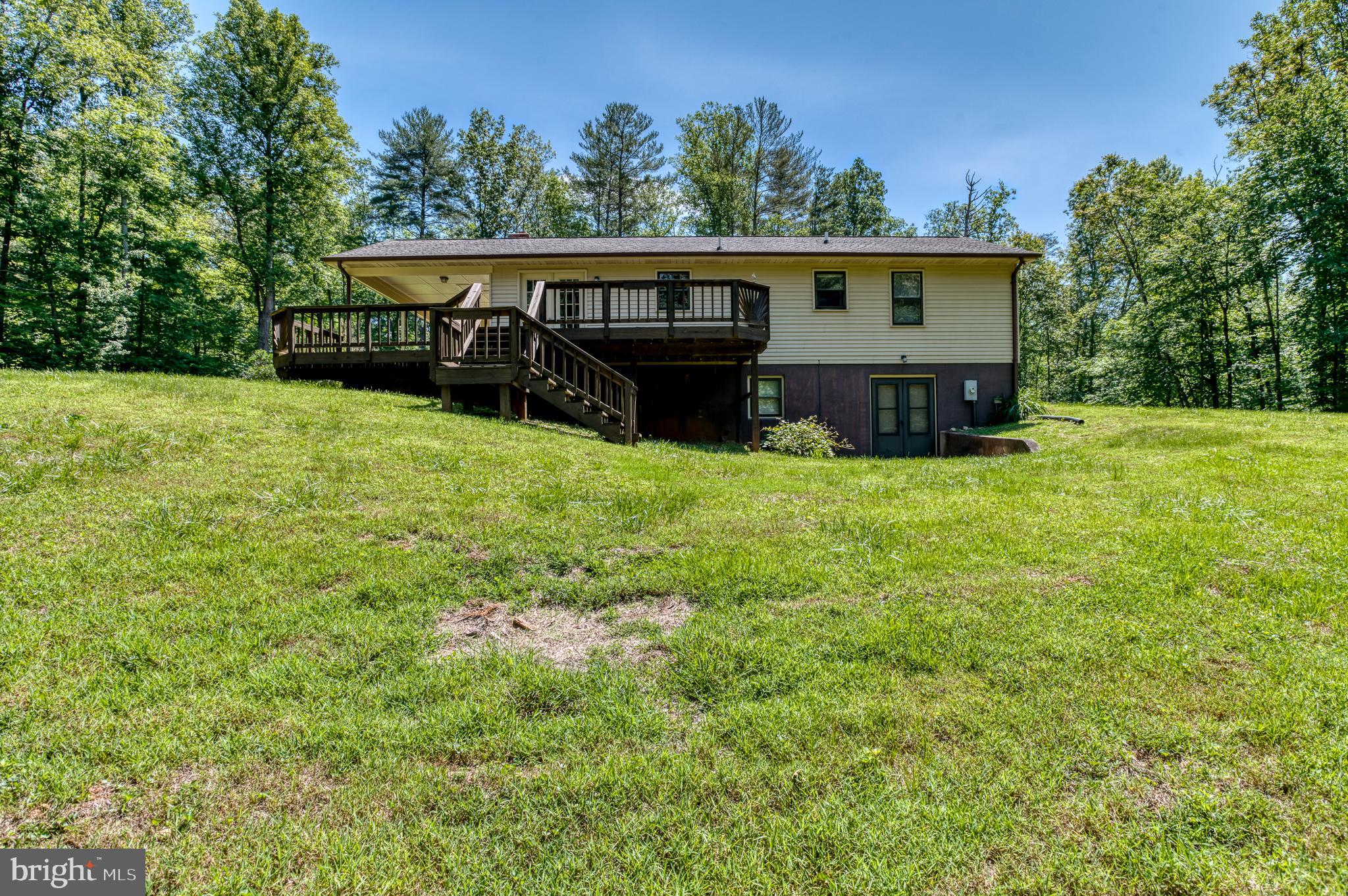 803 Weaver Hollow Road Banco, VA 22711 - Photo 28 of 67 a view of a house with backyard and a hammock