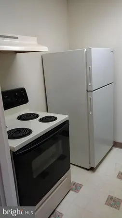 a stove top oven sitting inside of a kitchen