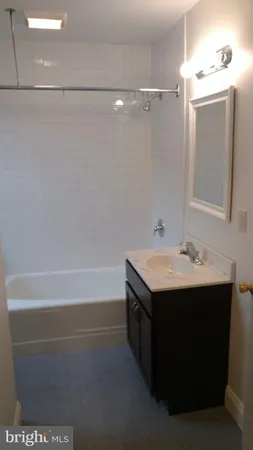 a bathroom with a sink and mirror