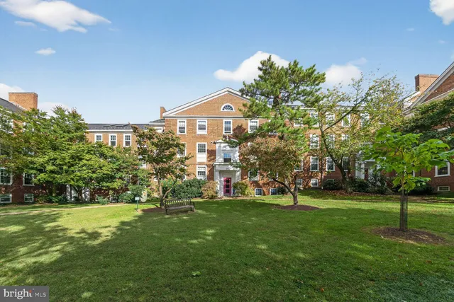 a view of a big house with a big yard and potted plants