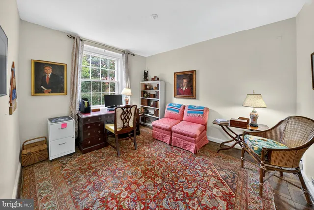 a living room with furniture a flat screen tv and a window