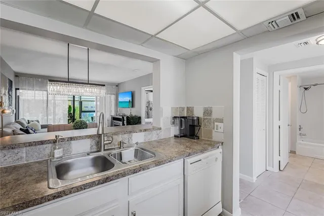 a bathroom with a sink a toilet and a large mirror