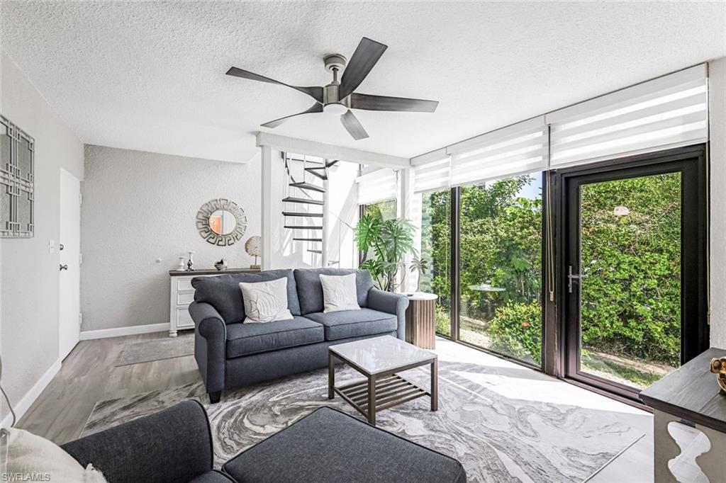 807 River Point Drive, Unit 102D Naples, FL 34102 - Photo 17 of 32 a living room with furniture and a large window