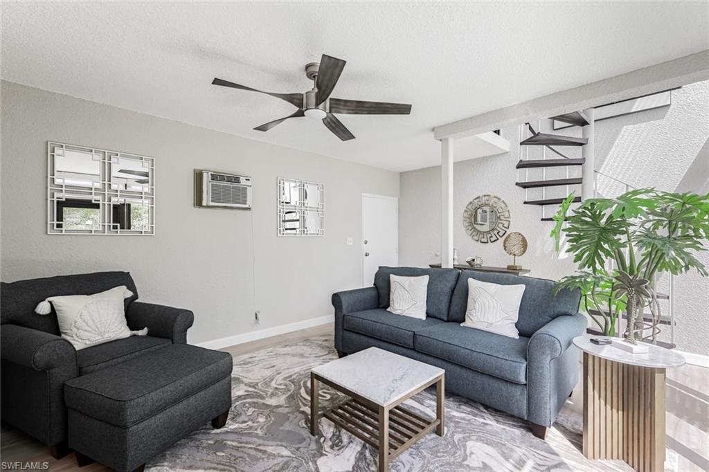 807 River Point Drive, Unit 102D Naples, FL 34102 - Photo 18 of 32 a living room with furniture and a window