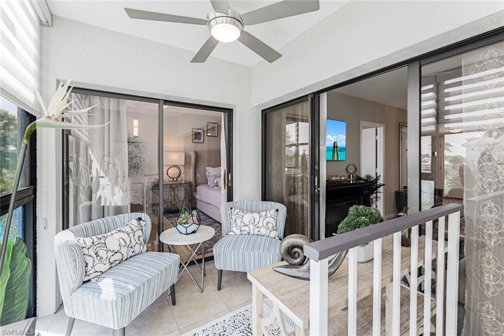 807 River Point Drive, Unit 102D Naples, FL 34102 - Photo 22 of 32 a living room with furniture and a large window