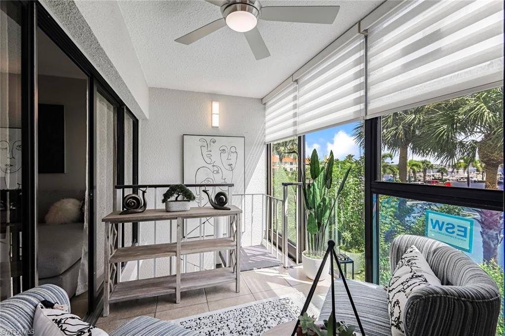 807 River Point Drive, Unit 102D Naples, FL 34102 - Photo 23 of 32 a living room with furniture and a large window