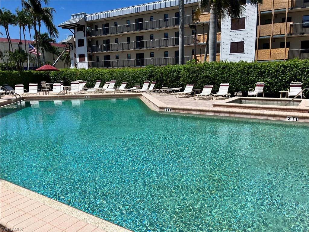 807 River Point Drive, Unit 102D Naples, FL 34102 - Photo 31 of 32 a swimming pool with outdoor seating and yard