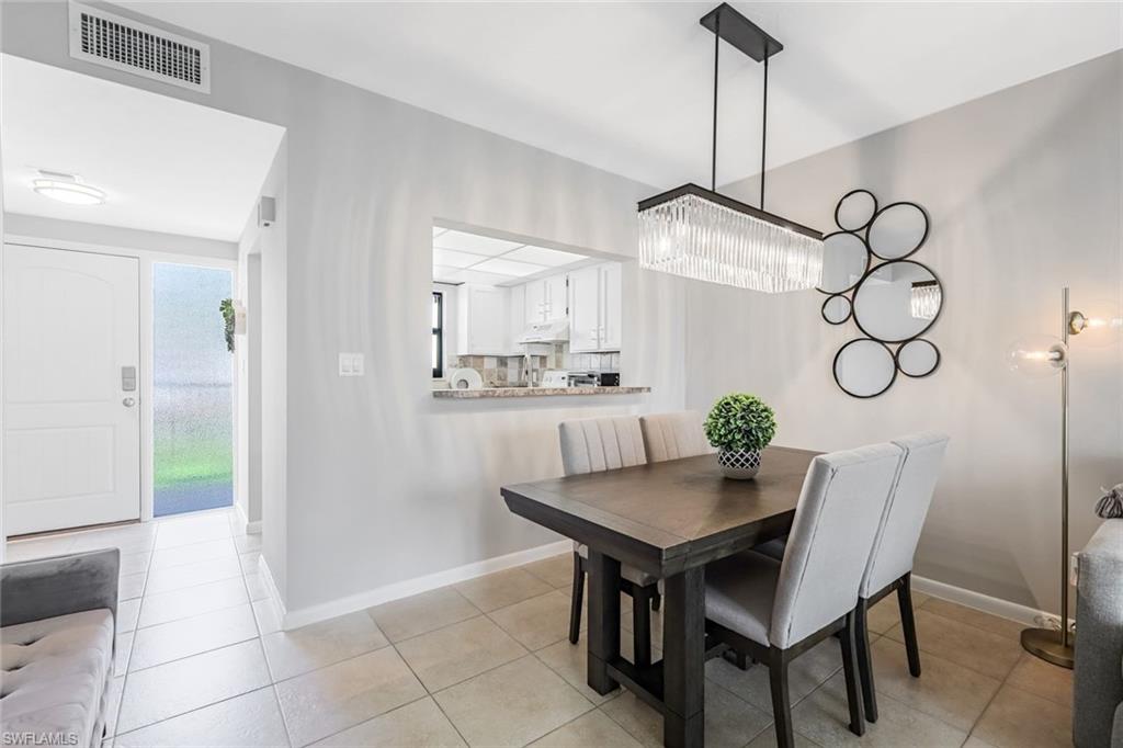 807 River Point Drive, Unit 102D Naples, FL 34102 - Photo 8 of 32 a view of a dining room with furniture and window