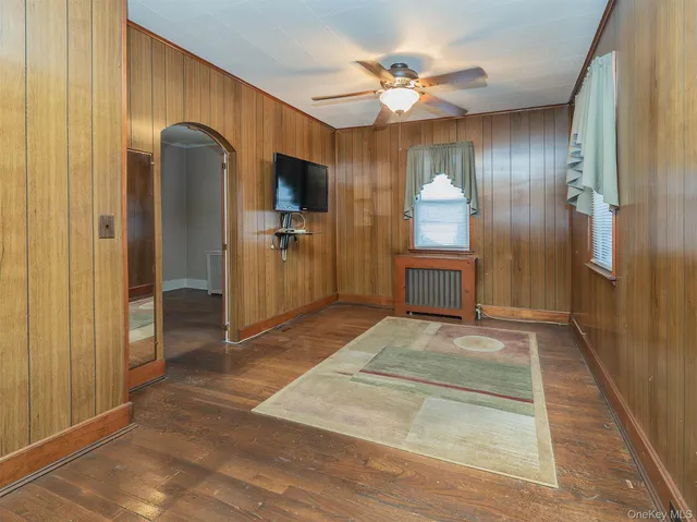 a spacious bedroom with a bed and a chandelier