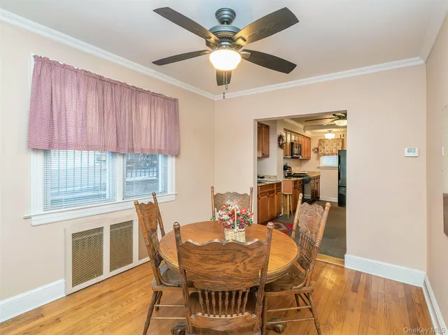 a dining room with furniture a window and wooden floor