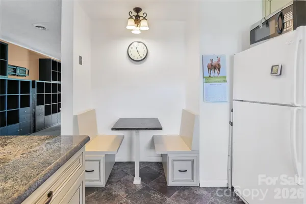 a kitchen with stainless steel appliances granite countertop a refrigerator and a stove
