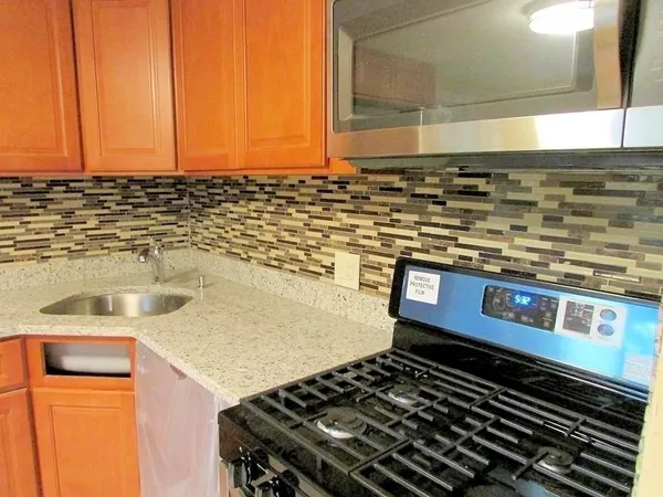 a kitchen with a stove and a sink