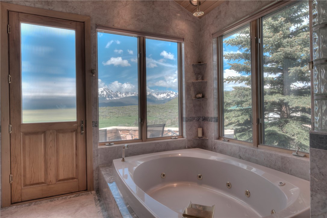 1996 Rodeo Drive Silverthorne, CO 80498 - Photo 28 of 35 a bathroom with shower and a bathtub next to a window