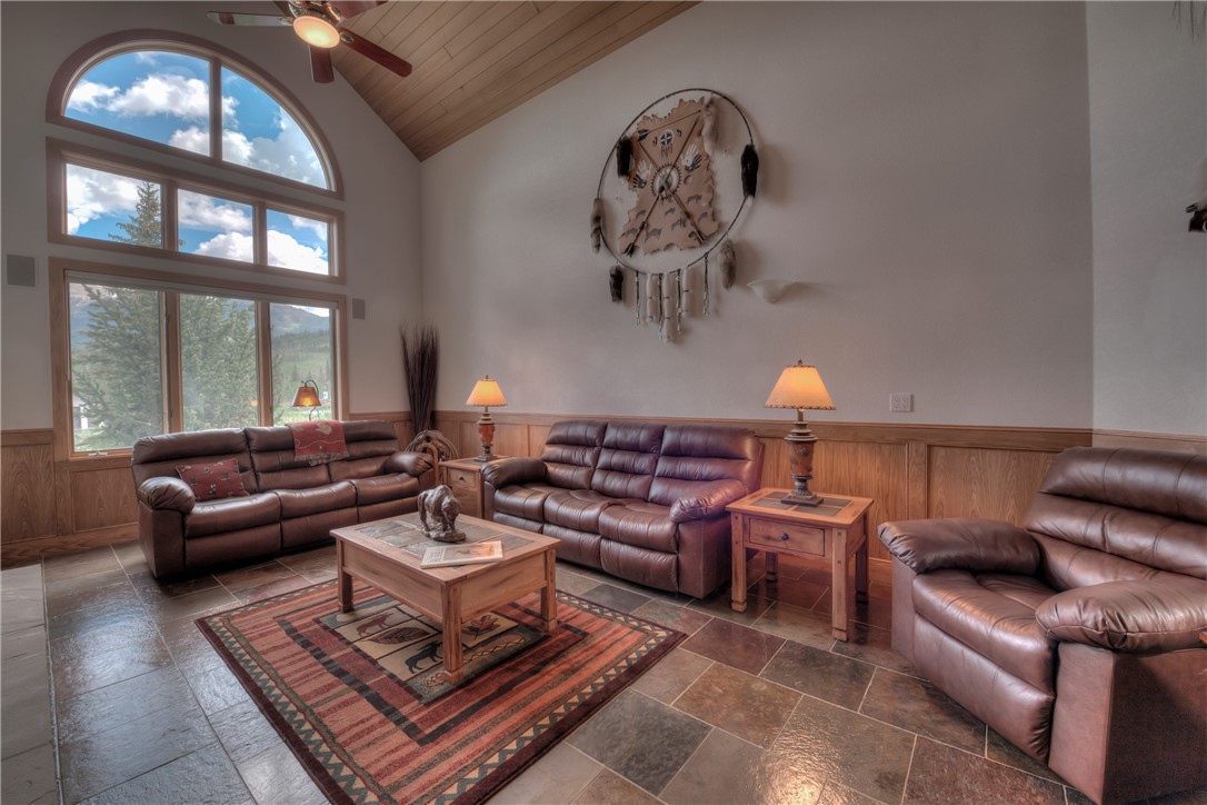 1996 Rodeo Drive Silverthorne, CO 80498 - Photo 32 of 35 a living room with furniture a chandelier and a large window