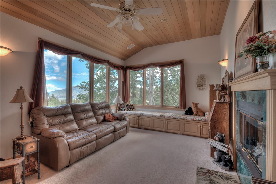 1996 Rodeo Drive Silverthorne, CO 80498 - Photo 34 of 35 a living room with furniture a flat screen tv and a floor to ceiling window