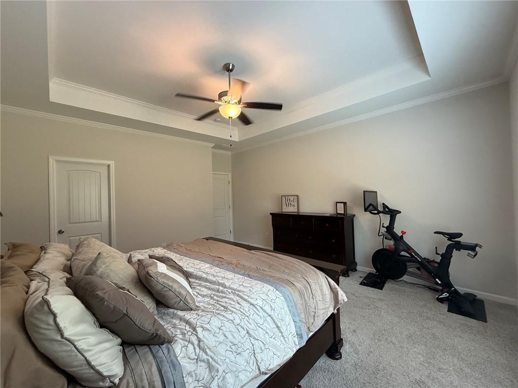 358 Mulberry Road Winder, GA 30680 - Photo 18 of 21 a bedroom with a bed and a chandelier