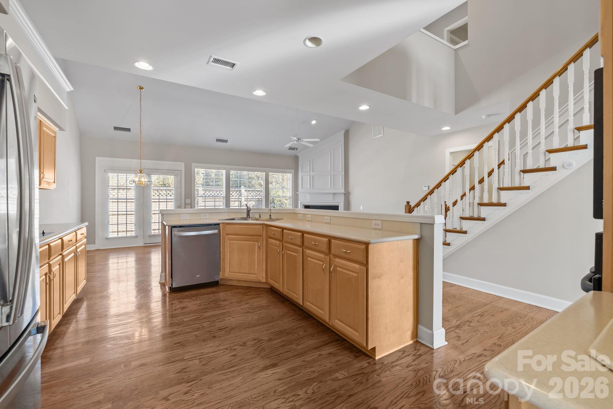 412 Eberle Way Matthews, NC 28105 - Photo 15 of 43 a kitchen with stainless steel appliances sink cabinets and wooden floor