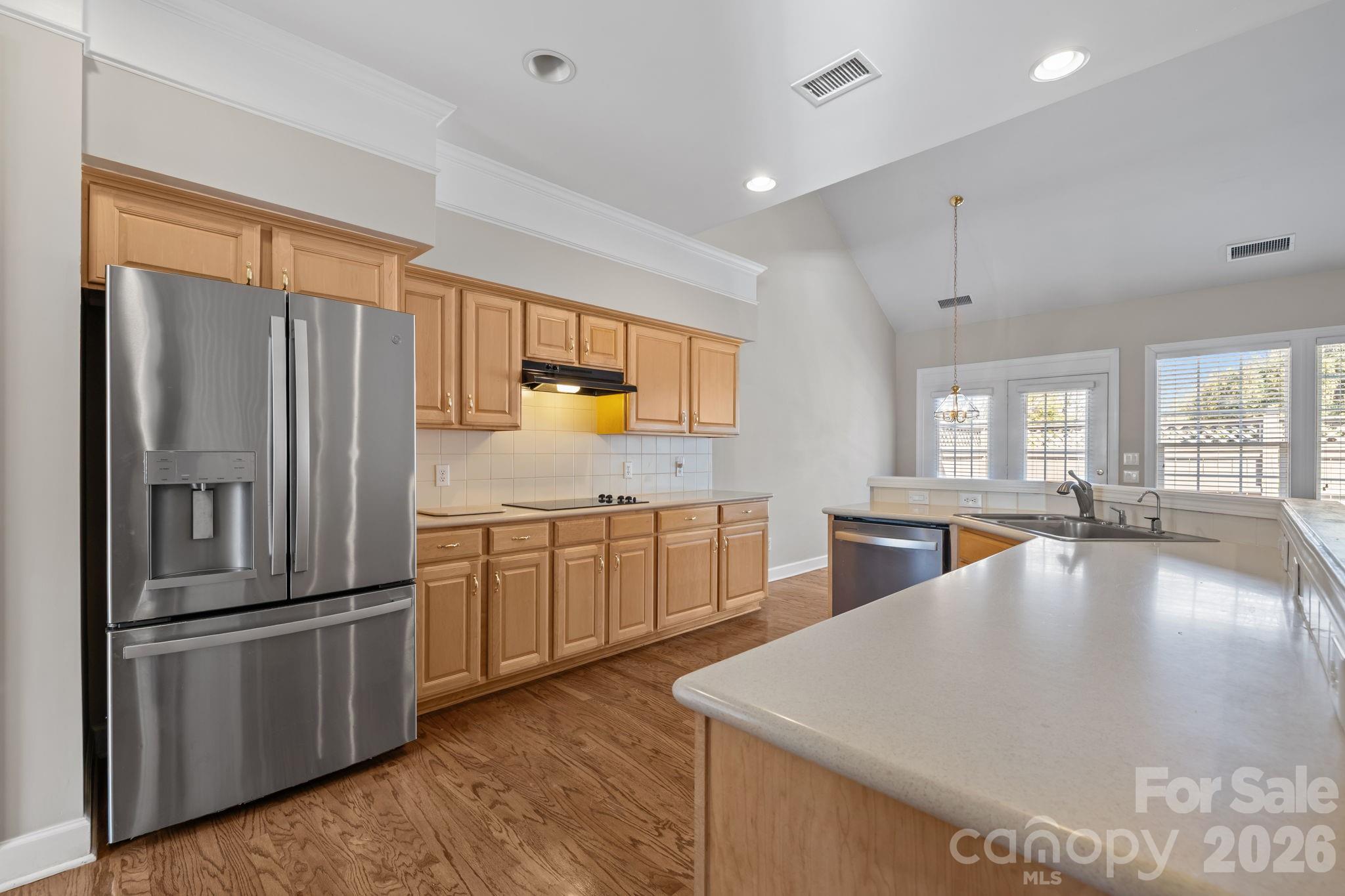 412 Eberle Way Matthews, NC 28105 - Photo 16 of 43 a large kitchen with kitchen island a large counter top space a sink stainless steel appliances and cabinets