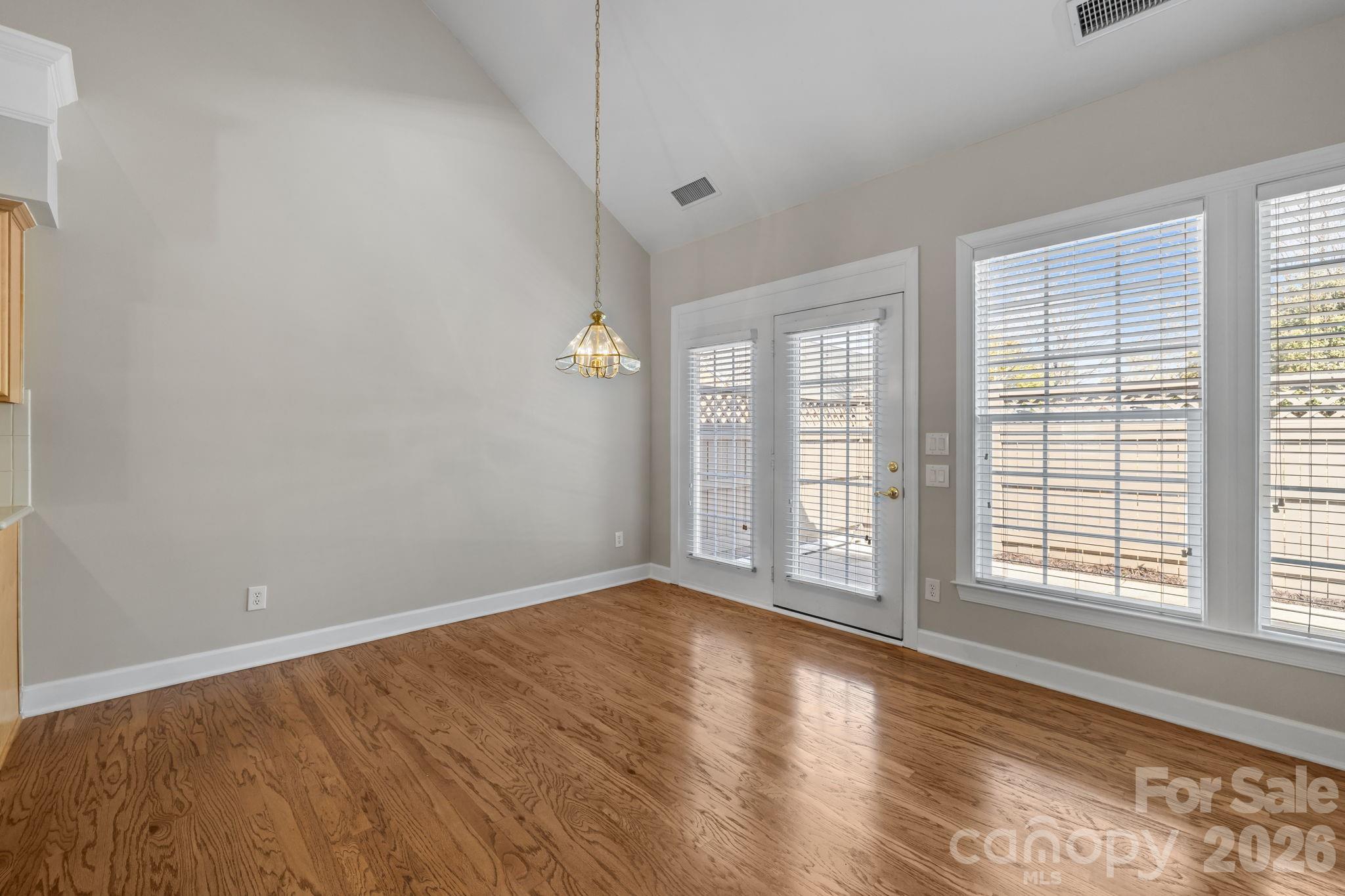 412 Eberle Way Matthews, NC 28105 - Photo 17 of 43 an empty room with wooden floor and windows