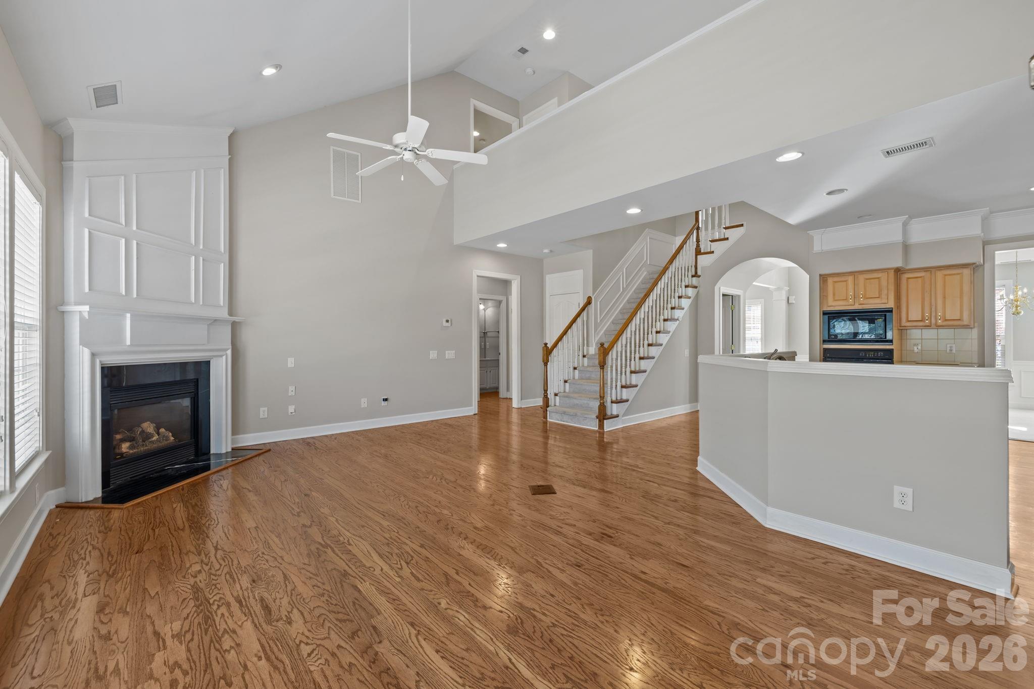412 Eberle Way Matthews, NC 28105 - Photo 18 of 43 a view of empty room with wooden floor and fireplace