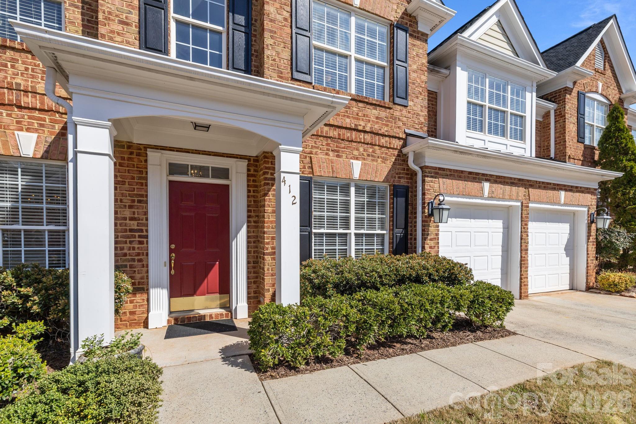 412 Eberle Way Matthews, NC 28105 - Photo 2 of 43 front view of a brick house