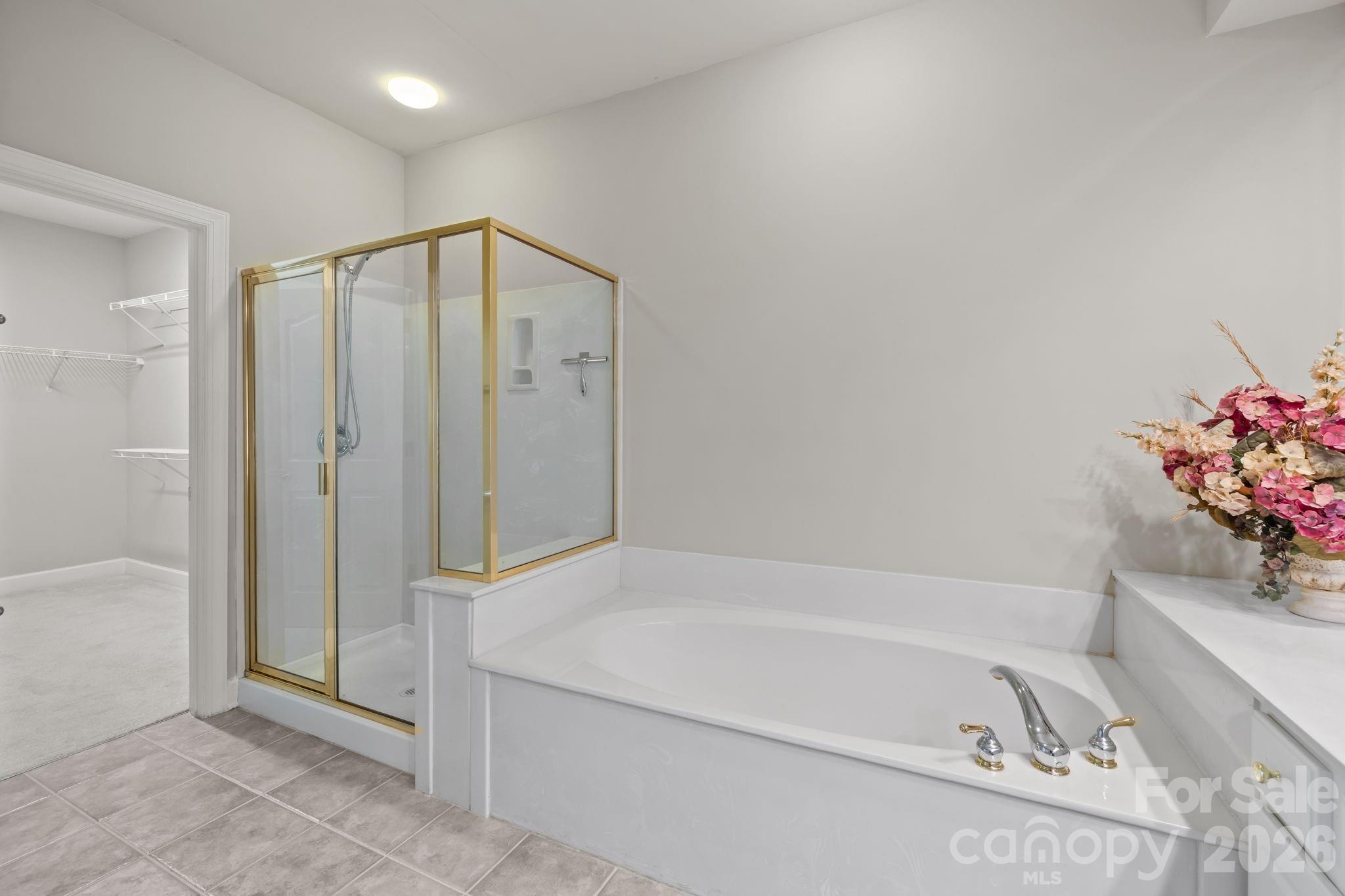 412 Eberle Way Matthews, NC 28105 - Photo 24 of 43 a bathroom with a bathtub and a shower