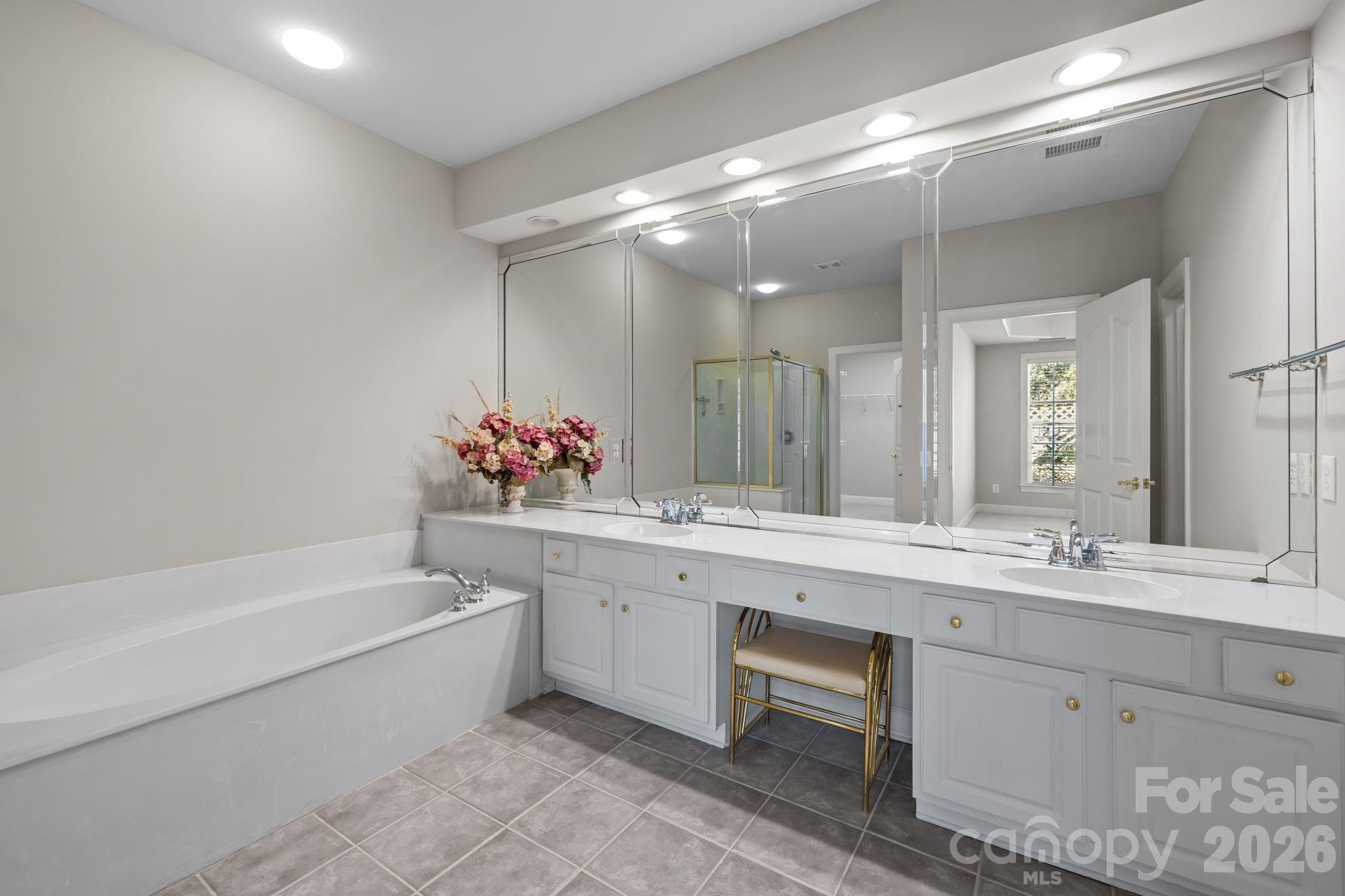 412 Eberle Way Matthews, NC 28105 - Photo 25 of 43 a bathroom with a bathtub sink and mirror