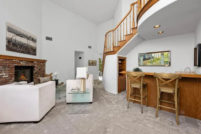 a living room with furniture a fireplace and a table