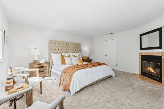 a bedroom with a bed and a fireplace