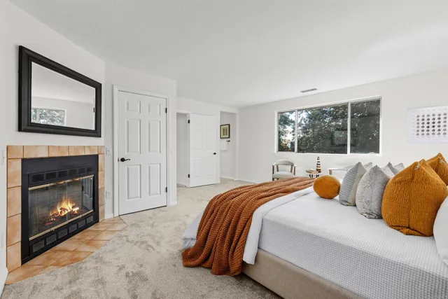 a bedroom with a bed and a fireplace