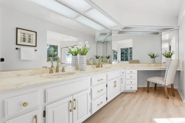 a spacious bathroom with double sink and a mirror