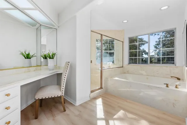 a spacious bathroom with a tub and shower