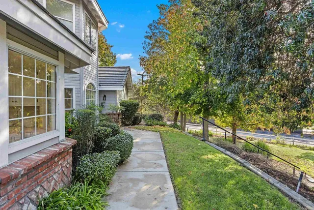 a front view of a house with a garden