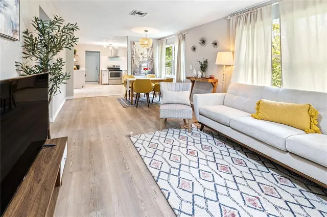 a living room with furniture fireplace and a large window