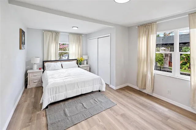 a bedroom with a large bed and a window