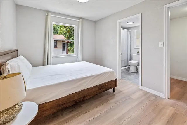 a bedroom with a bed and a window