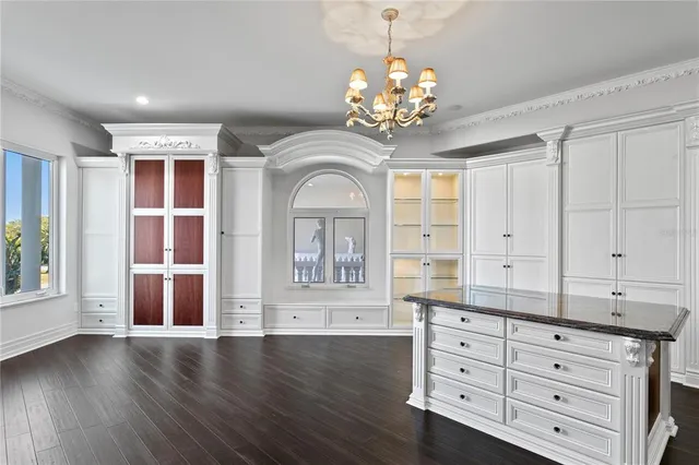 a view of a dining room with furniture wooden floor and chandelier