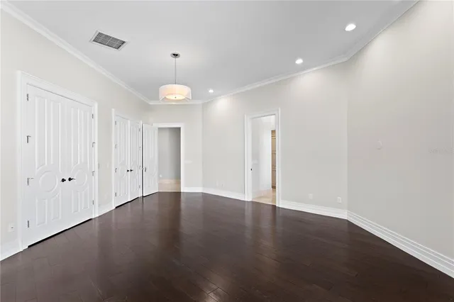 a living room with furniture tv and large windows