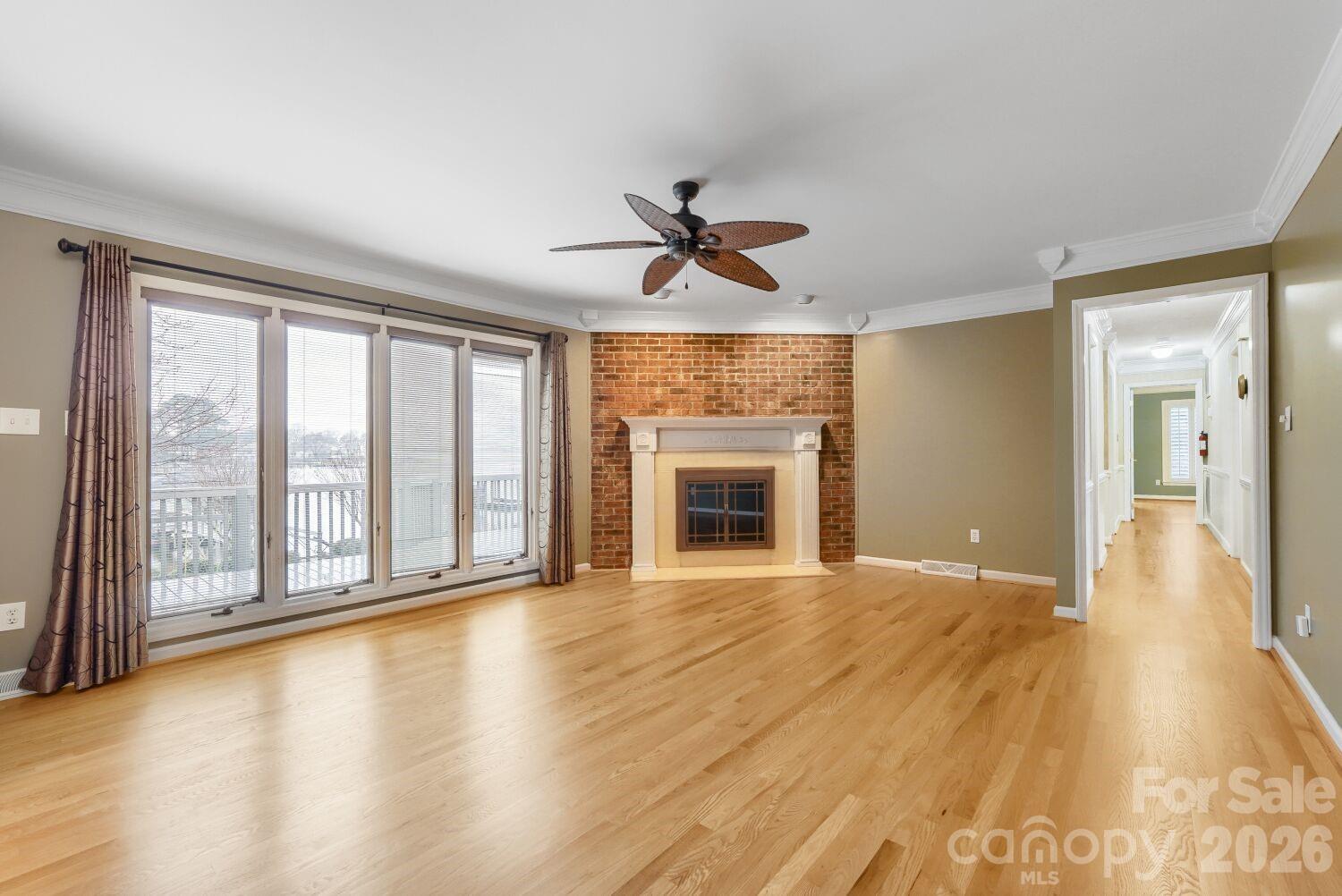 22527 John Gamble Road Cornelius, NC 28031 - Photo 13 of 33 wooden floor in an empty room with a fireplace