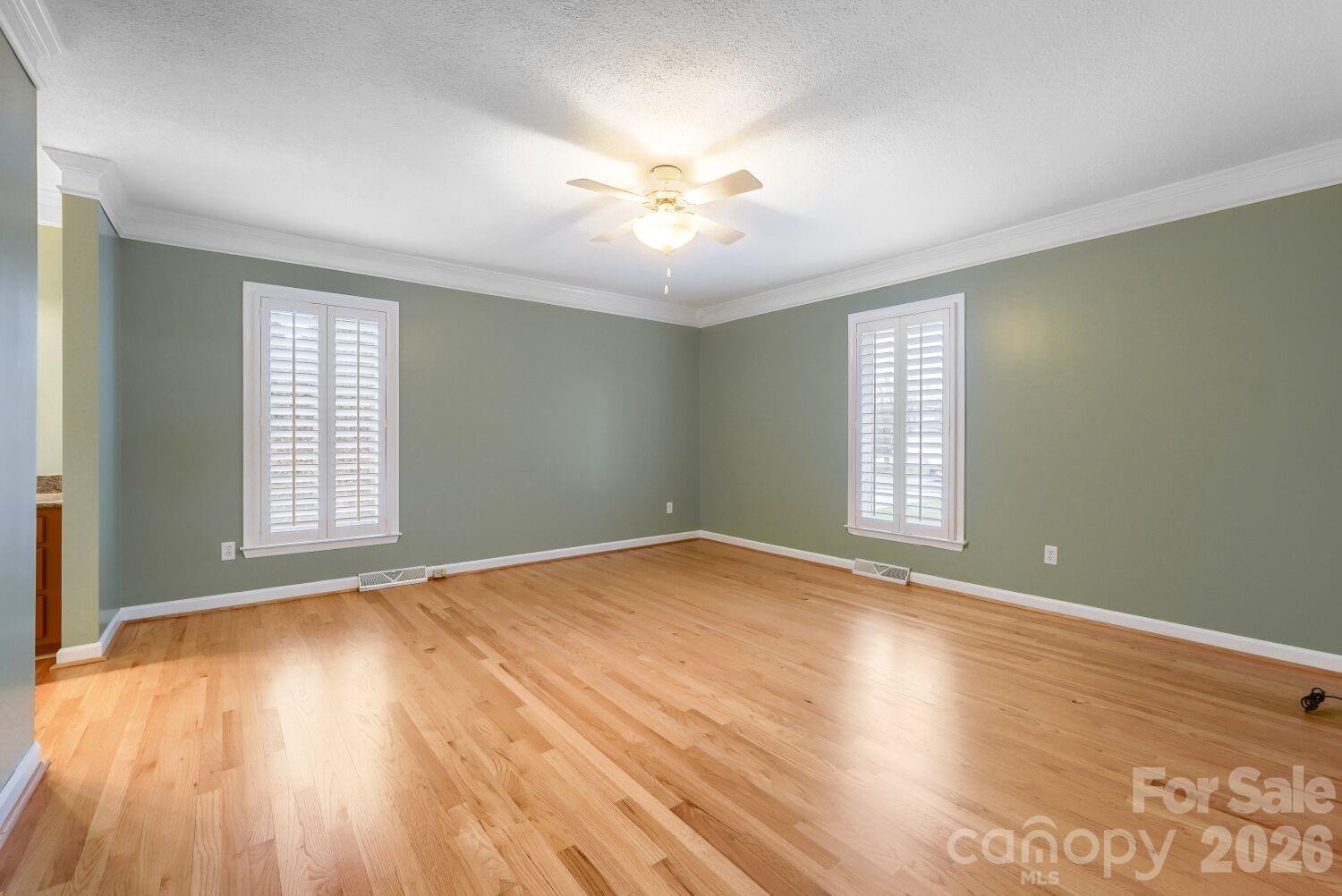 22527 John Gamble Road Cornelius, NC 28031 - Photo 17 of 33 an empty room with wooden floor and windows