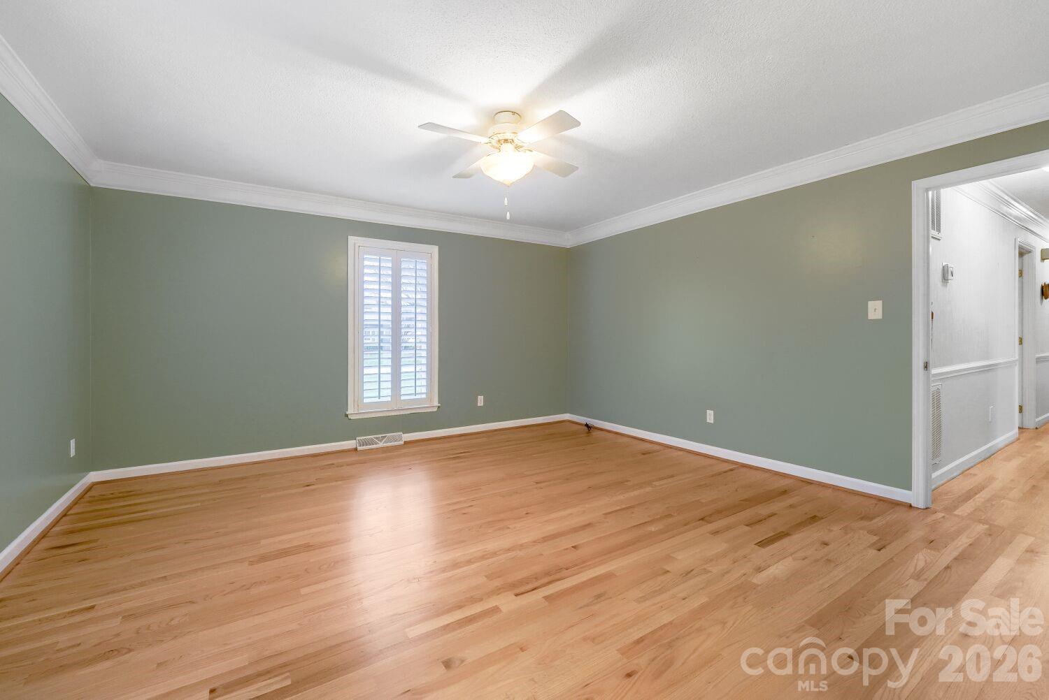 22527 John Gamble Road Cornelius, NC 28031 - Photo 18 of 33 an empty room with wooden floor and windows