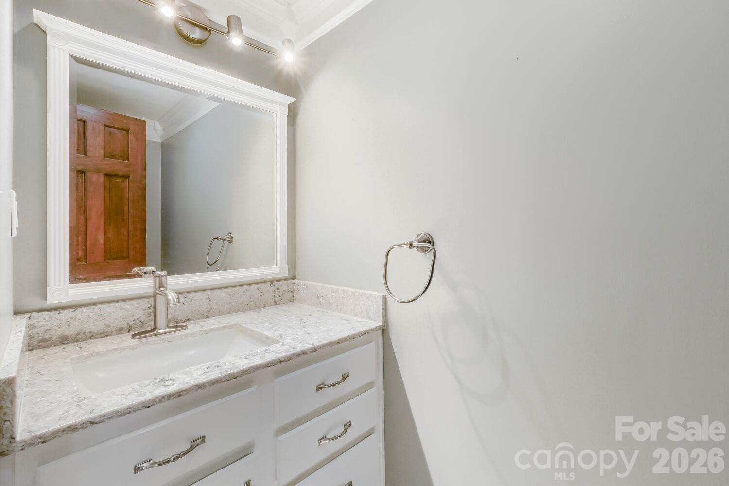22527 John Gamble Road Cornelius, NC 28031 - Photo 24 of 33 a bathroom with a granite countertop sink and a mirror