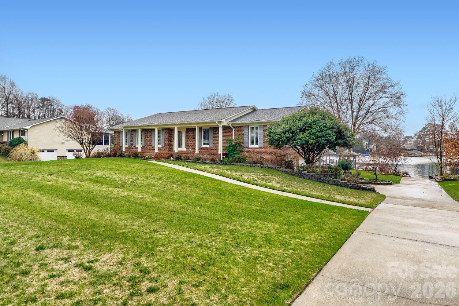 22527 John Gamble Road Cornelius, NC 28031 - Photo 3 of 33 a view of a house with a big yard and large trees