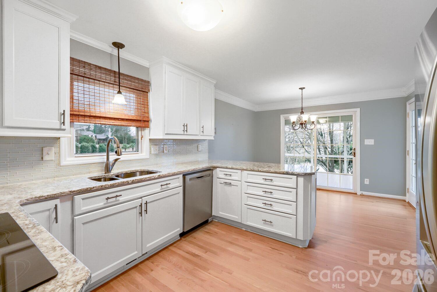 22527 John Gamble Road Cornelius, NC 28031 - Photo 9 of 33 a kitchen with granite countertop a sink window and cabinets