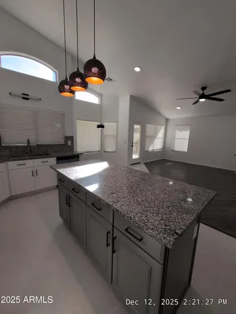 a kitchen with stainless steel appliances granite countertop a sink a stove and a refrigerator